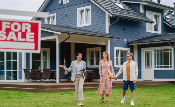 image of a house with a for sale sign in the front, with three people walking towards the sign